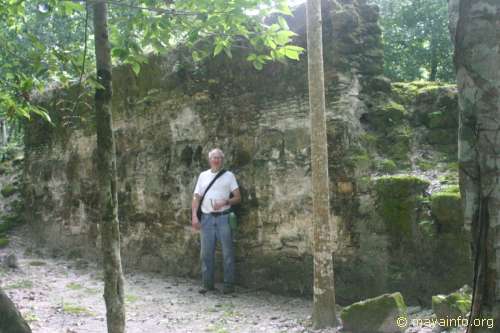 John Mack in front of a structure at Nakbe.